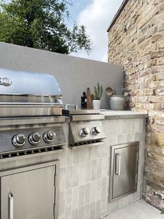 an outdoor kitchen with stainless steel appliances