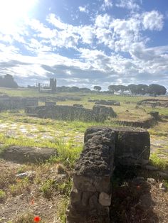 an old stone structure sitting in the middle of a field