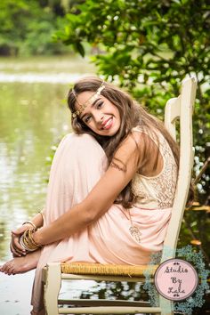 a beautiful woman sitting on top of a wooden bench