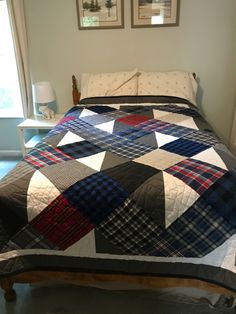 a bed with a quilt on top of it