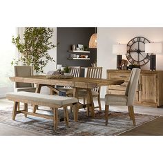 a dining room table and chairs with a clock in the background