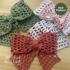 four crocheted bow ties on top of a wooden table