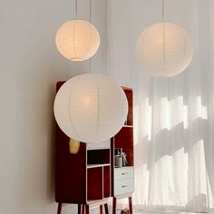 three lamps hanging from the ceiling in a room