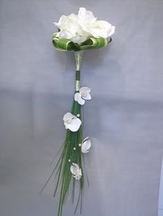 a bouquet of white flowers is hanging on the wall