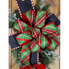 a green and red christmas wreath on a door