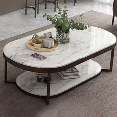 a marble coffee table with plants on top