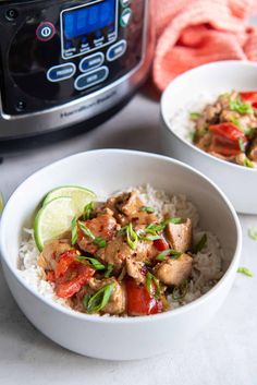 two bowls filled with rice, meat and vegetables next to an instant pressure cooker