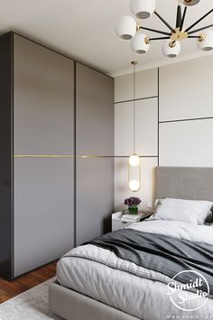 a bedroom with a large bed and two lamps hanging from the ceiling over it's headboard