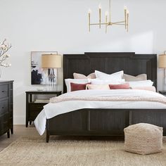 a bedroom with a bed, nightstands and lamps