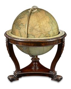 an old world globe sitting on top of a wooden stand