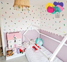 a child's bedroom with pink walls and sprinkles on the wall