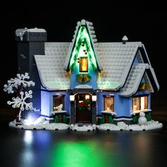 a lit up house with snowflakes on the roof