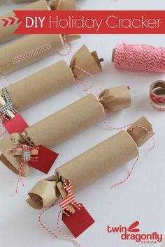 several rolls of brown paper with red and white twine tied to them on a table