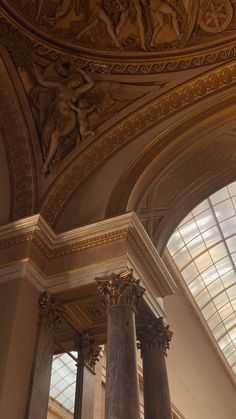 the interior of a building with columns and windows