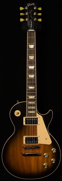 an electric guitar sitting on top of a black surface