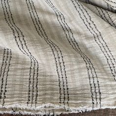 an old blanket with black and white lines on it