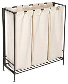 three canvas storage bins with black metal frame and four white fabric bags hanging from the bottom