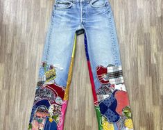 the jeans are decorated with colorful patches and designs