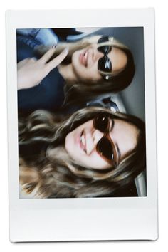 two young women with sunglasses are posing for a photo in front of a white frame