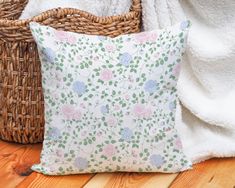 a pillow sitting on top of a wooden floor next to a basket