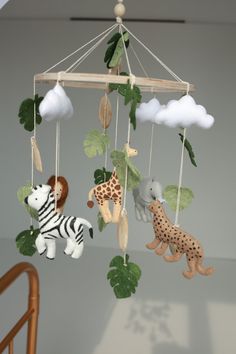 an animal mobile hanging from the ceiling in a child's playroom or nursery