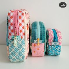 three pieces of colorful luggage sitting next to each other on a white surface with one piece missing