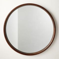 a round mirror hanging on the wall