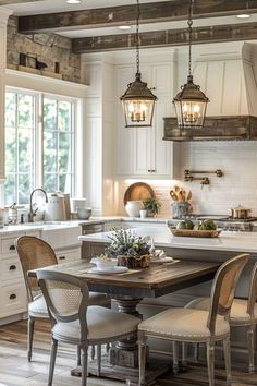 a kitchen with white cabinets and an island in front of the counter top, surrounded by chairs