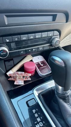 the interior of a car with various items in it's center console and dash board