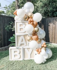 an outdoor birthday party with balloons and letters