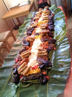 a long table topped with lots of meat and veggies on top of it