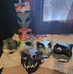 five masks are lined up on a table