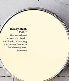 an overhead view of a jar of honey moth cream on a tile floor with the words honey moth written below it