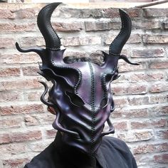 This is the XL version of one of my handcrafted dragon mask. You can choose the color on the dropdown menu. All color options come with black horns, black thread and accents. please leave a note at check out or send me a message if you want to change anything. Forged from vegetable-tanned leather, it enwraps wearers of any gender in its shadowy embrace. With adjustable leather straps, it fits snugly on standard adult visages, ensuring diabolical comfort. Just so you know, color displays may vary on different screens. But don't fret! for behind its fearsome façade lies unexpected clarity! Peer through the mesh eyeholes and witness the world with razor-sharp focus, all while exuding enigmatic mystique. Shipping insurance is not included but you may safeguard your treasure for a mere pittance Devil Mask, Dragon Mask, Japanese Dragon, Costume Mask, Black Thread, Burning Man, Handcrafted Leather, Vegetable Tanned Leather, Larp