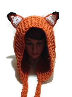 a doll wearing an orange knitted hat with fox ears on it's head