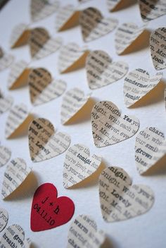 paper hearts with words written on them are arranged in the shape of small heart shapes