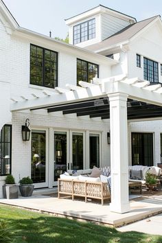 a large white house with an attached patio