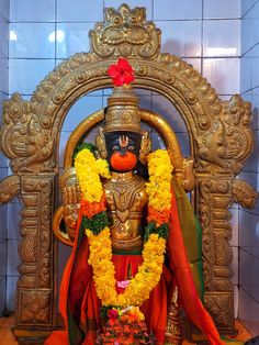 the statue is decorated with flowers and garlands