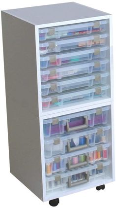 two drawers with plastic bins on each side and various craft supplies in the bottom drawer