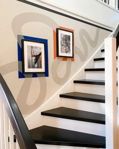 some black and white stairs with pictures on the wall