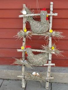 an old ladder is decorated with hay and chickens