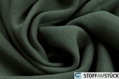 a close up shot of a dark green fabric