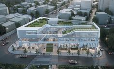 an aerial view of a large building with many windows and lots of greenery on the roof