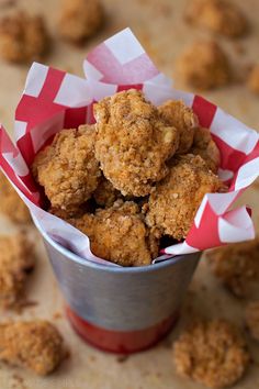 a bucket filled with fried food sitting on top of a table