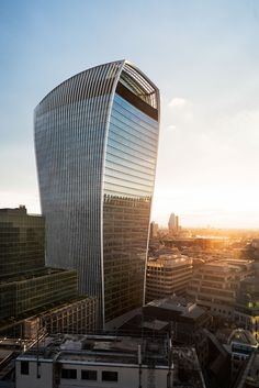 an aerial view of a tall building in the middle of a city with skyscrapers