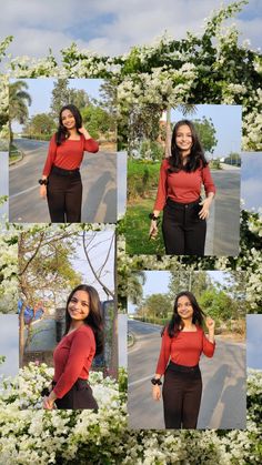 a woman in red shirt and black pants standing next to trees with white flowers on it