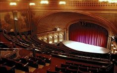 an empty theater stage with red curtains