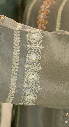 a close up of a person's arm with an embroidered design on the sleeve