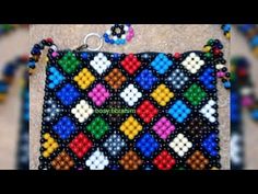 the beaded purse is decorated with multicolored squares