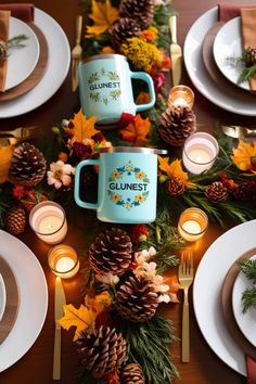 the table is set with pine cones, candles and plates for dinner guests to enjoy